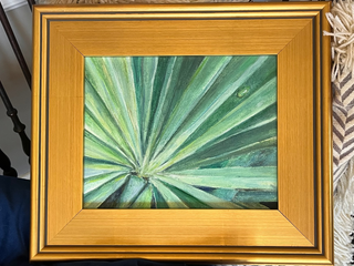 Framed artwork of a green palm leaf close-up painting in gold plein air frame
