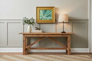 Framed painting of a green leaf pattern on a reclaimed console table.
